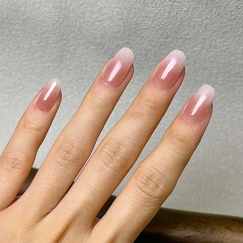 Nue press-on nails worn on hand — crossed-hand pose