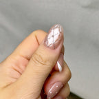 Coco press-on nails worn on hand — quilted crystal accent